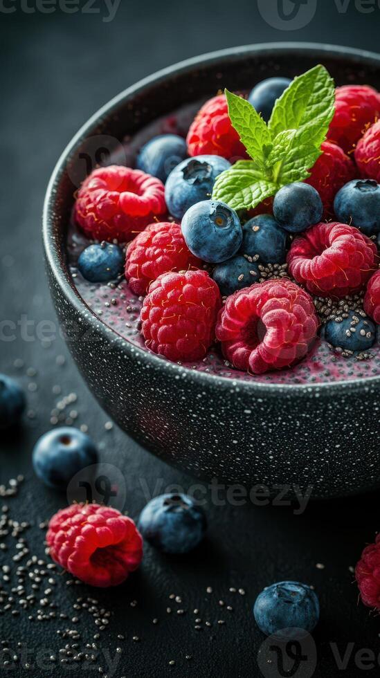 Fresh berries and chia seeds create a vibrant and nutritious bowl on a dark surface photo