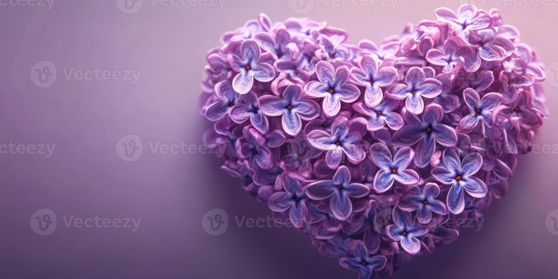 Heart-shaped arrangement of delicate purple flowers on a soft gradient background photo