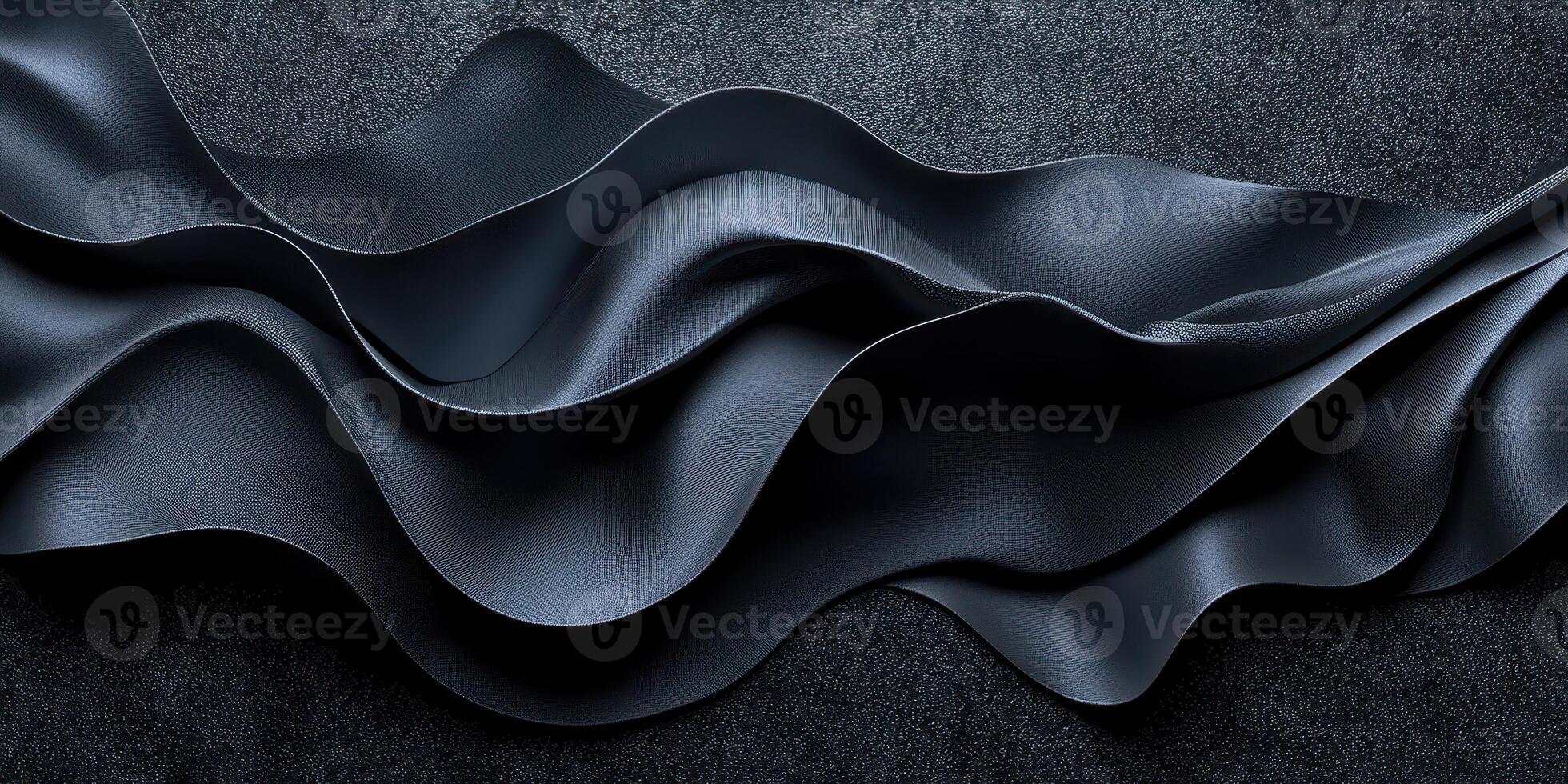 Flowing black fabric with elegant curves and texture on a dark background creates a stylish and modern appearance photo