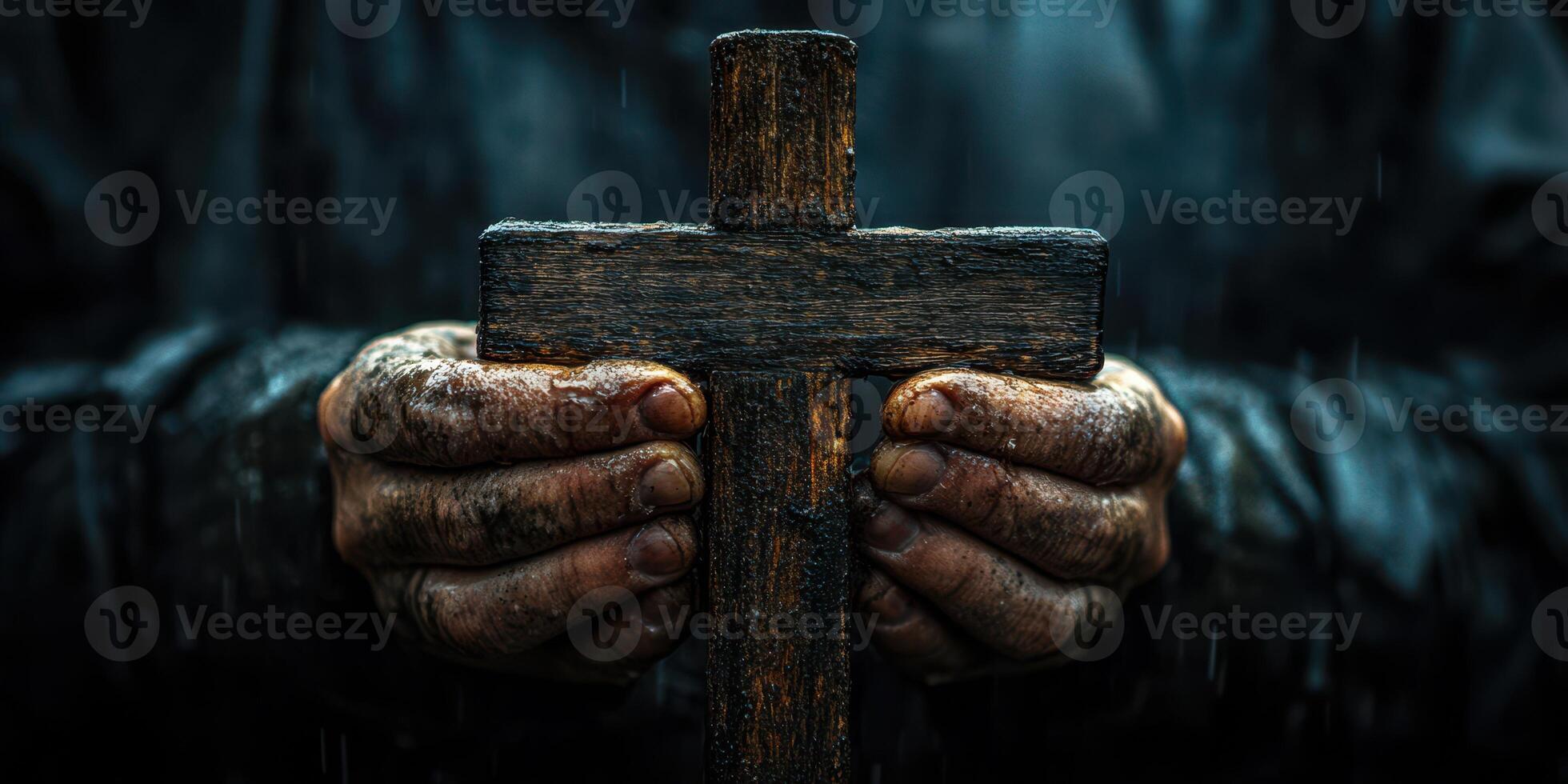 Hands holding a weathered wooden cross under rain showcasing faith and hope in a challenging moment photo