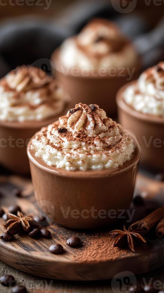 Creamy desserts topped with chocolate and whipped cream served in elegant brown cups on a rustic wooden surface photo