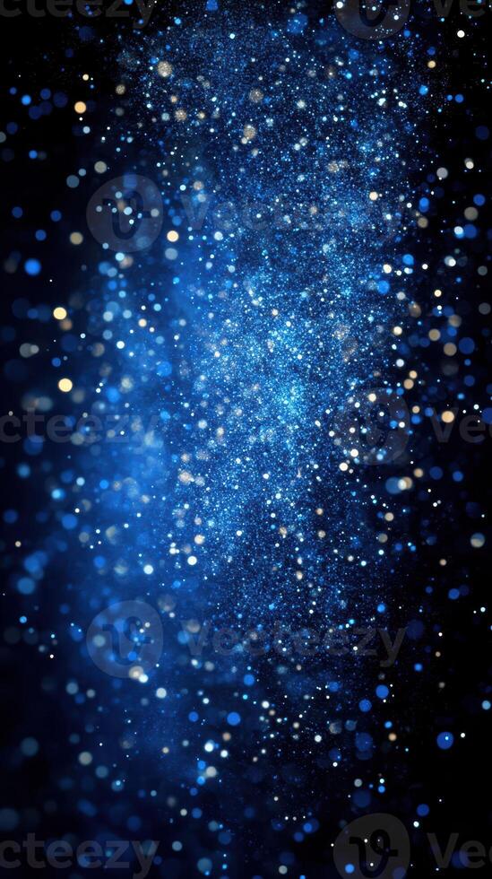 Bright blue particles sparkling in a dark background during a nighttime event photo