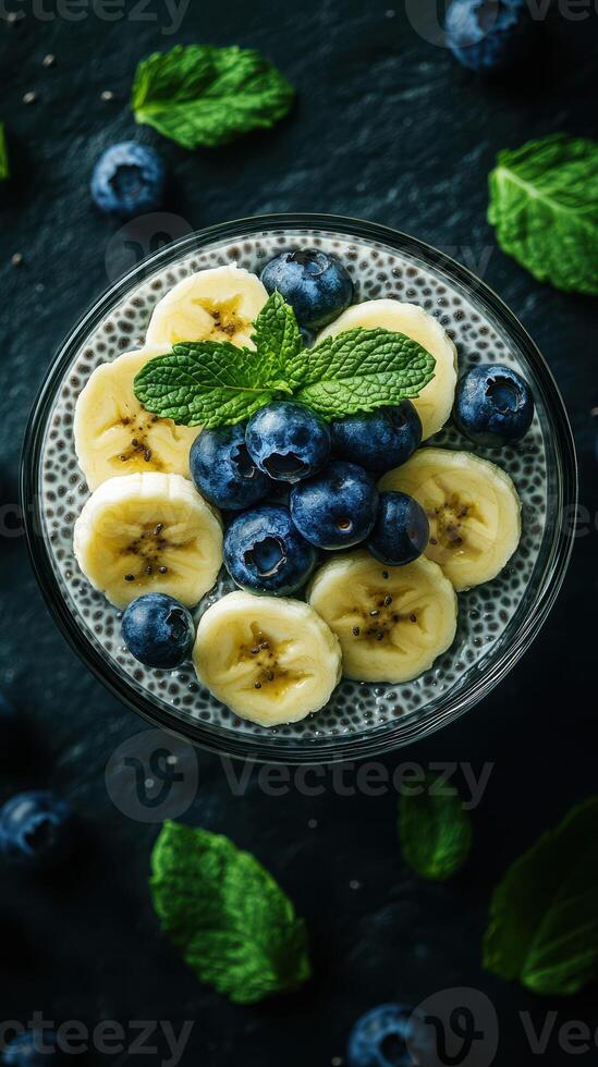 Delicious chia seed pudding topped with banana slices and fresh blueberries for a nutritious breakfast photo