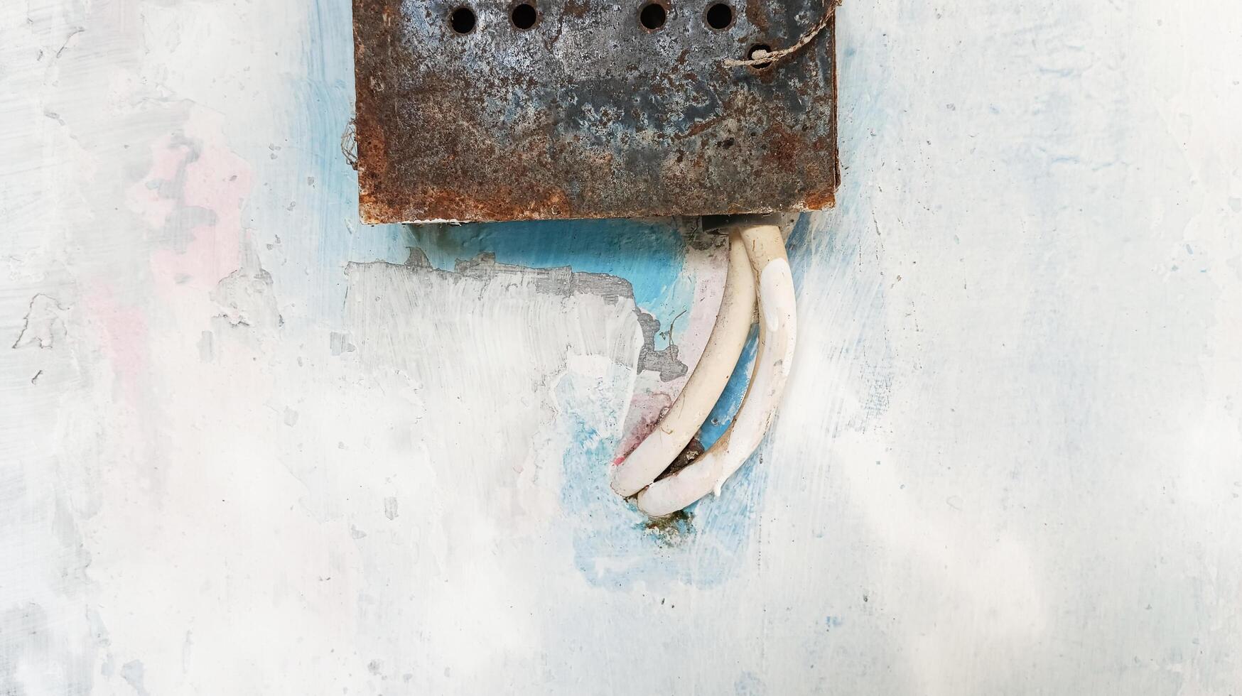 The electricity meter is rusty and old. photo