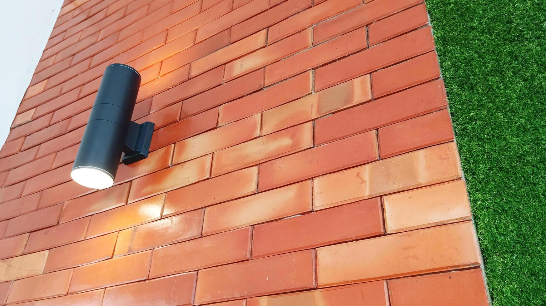 Outdoor lighting displays on exposed red bricks with close-up. photo