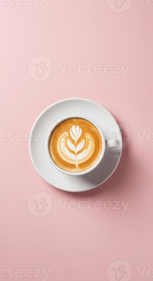 A cup of coffee with a leaf design on top photo