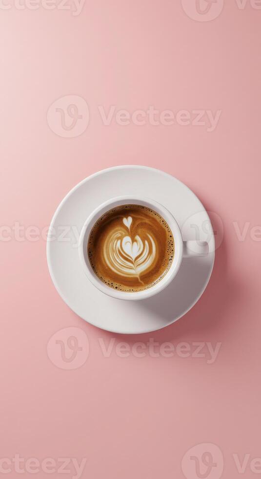 A cup of coffee with a heart in the middle on a pink background photo