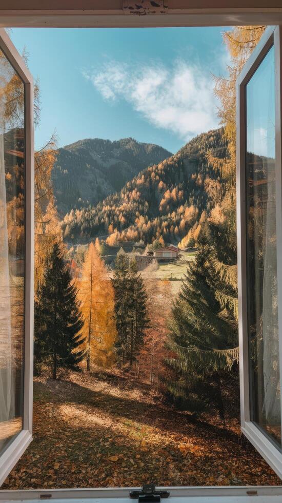View from an open window to the mountns and forest on a sunny autumn day photo
