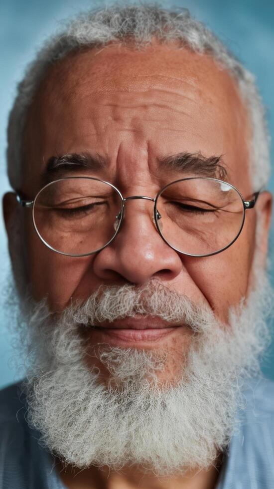 An older man with glasses and a beard photo