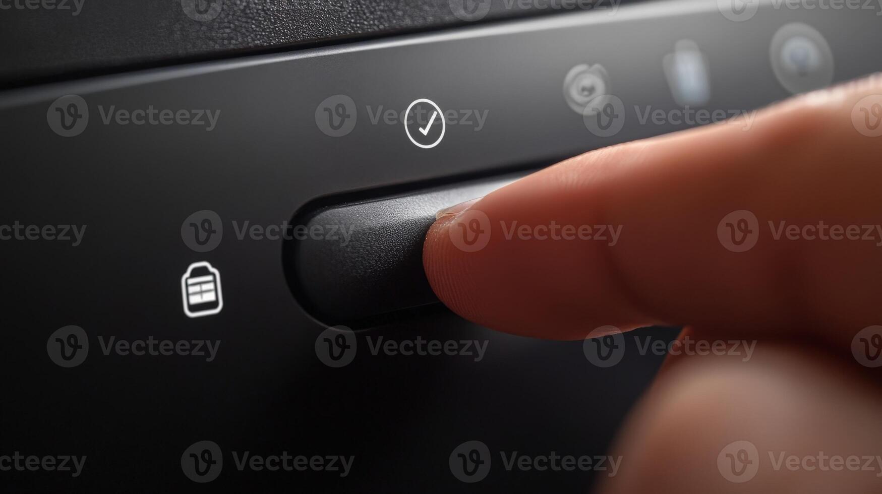 Finger pressing power button to activate car security system photo