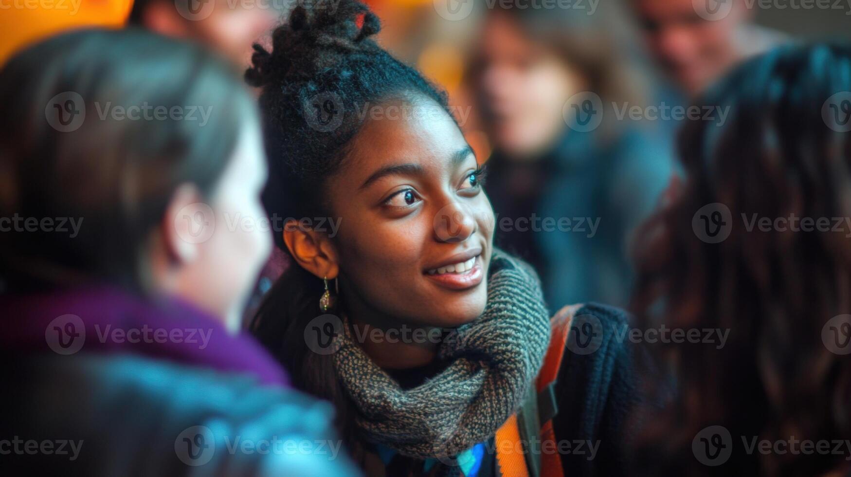 Young filmmaker smiling and networking during a film festival photo