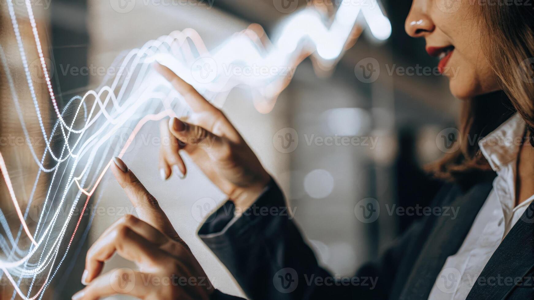 A closeup of a woman interacting with a holographic interface her fingers reaching out to manipulate swirling data visuals that represent market trends.. photo