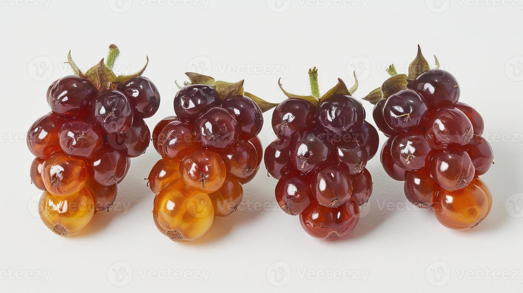 A close-up of clusters of grapes in varying shades of purple and orange against a white background. photo