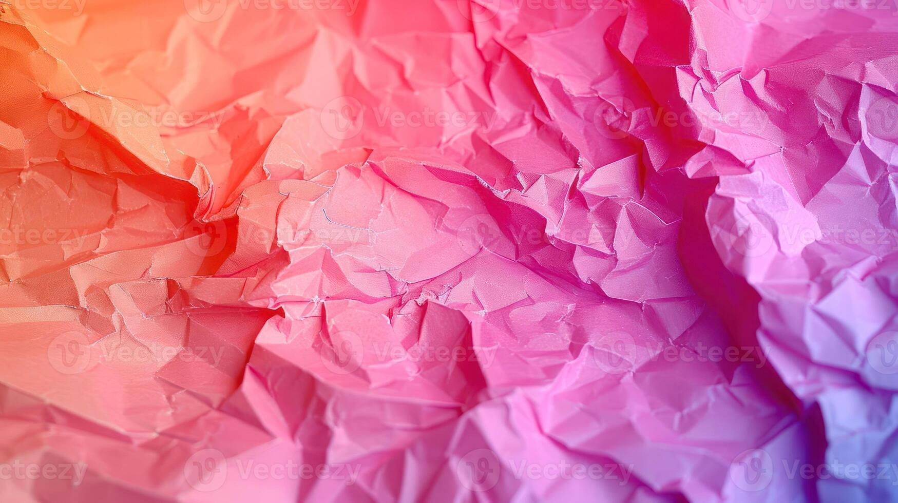 A vibrant, crumpled paper texture with gradients of pink and orange hues. photo