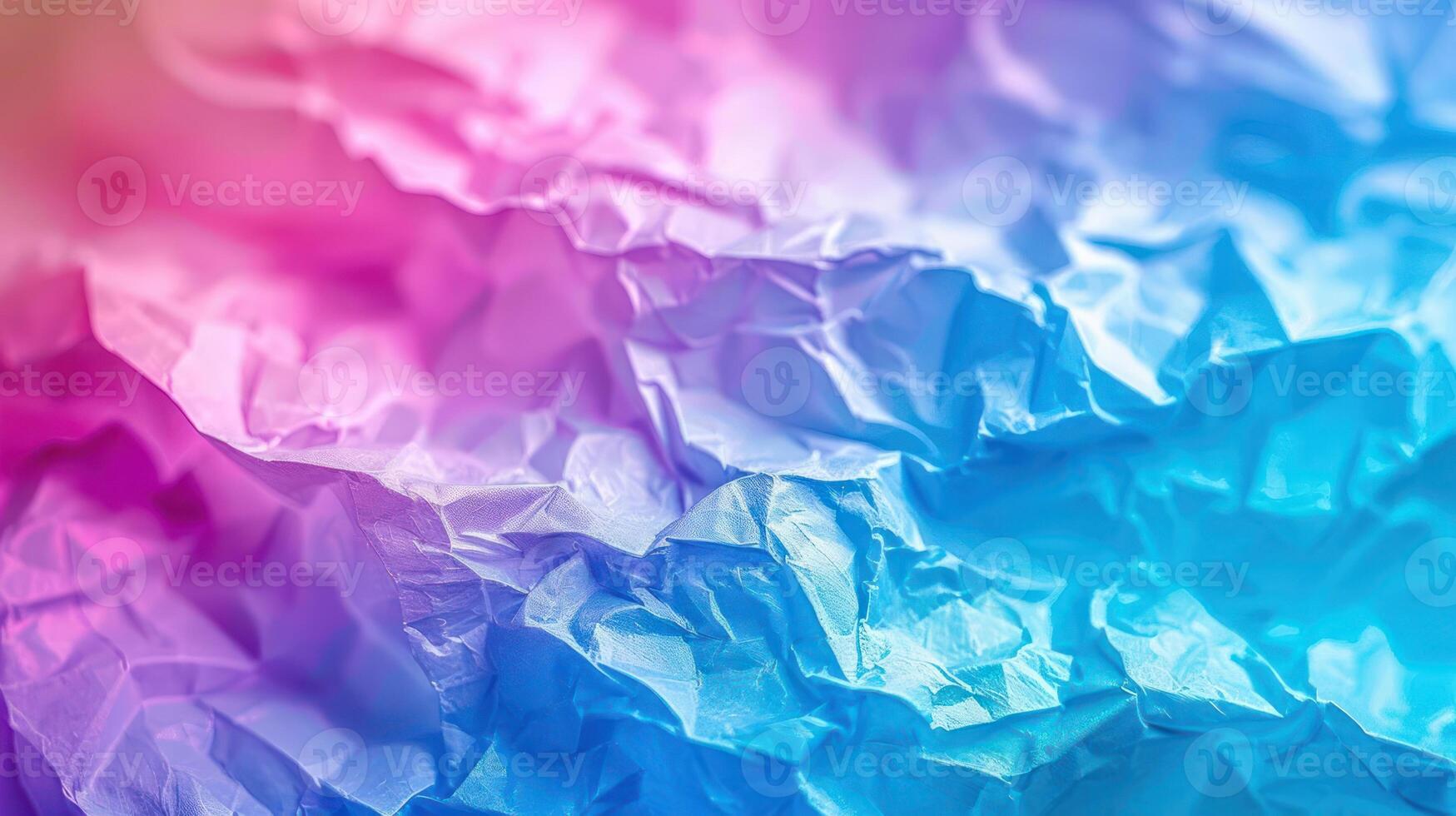 A close-up of crumpled paper with a gradient of pink and blue hues. photo