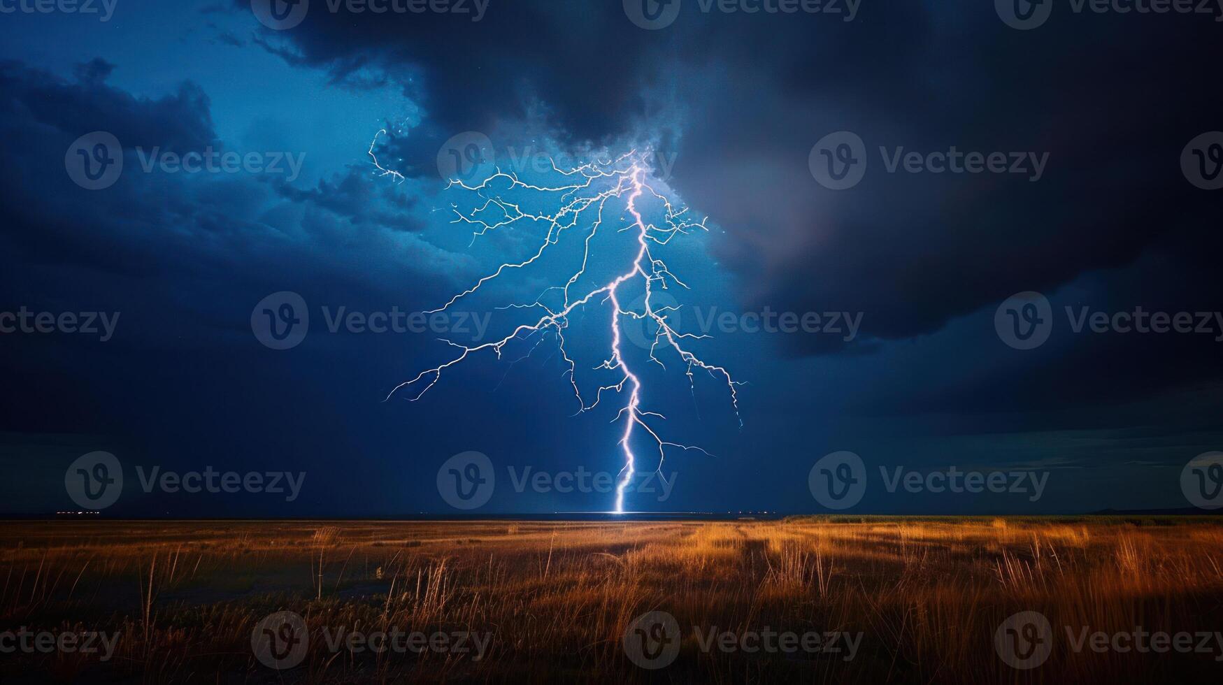 A dramatic lightning strike illuminates a stormy sky over a field at dusk. photo