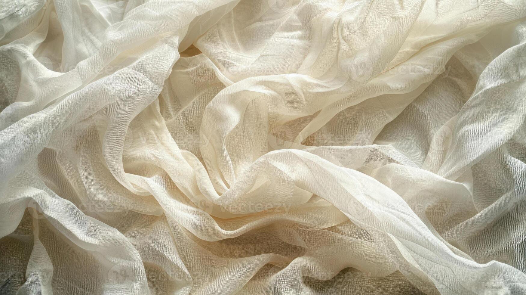 A close-up view of soft, flowing cream-colored fabric showcasing elegant draping. photo
