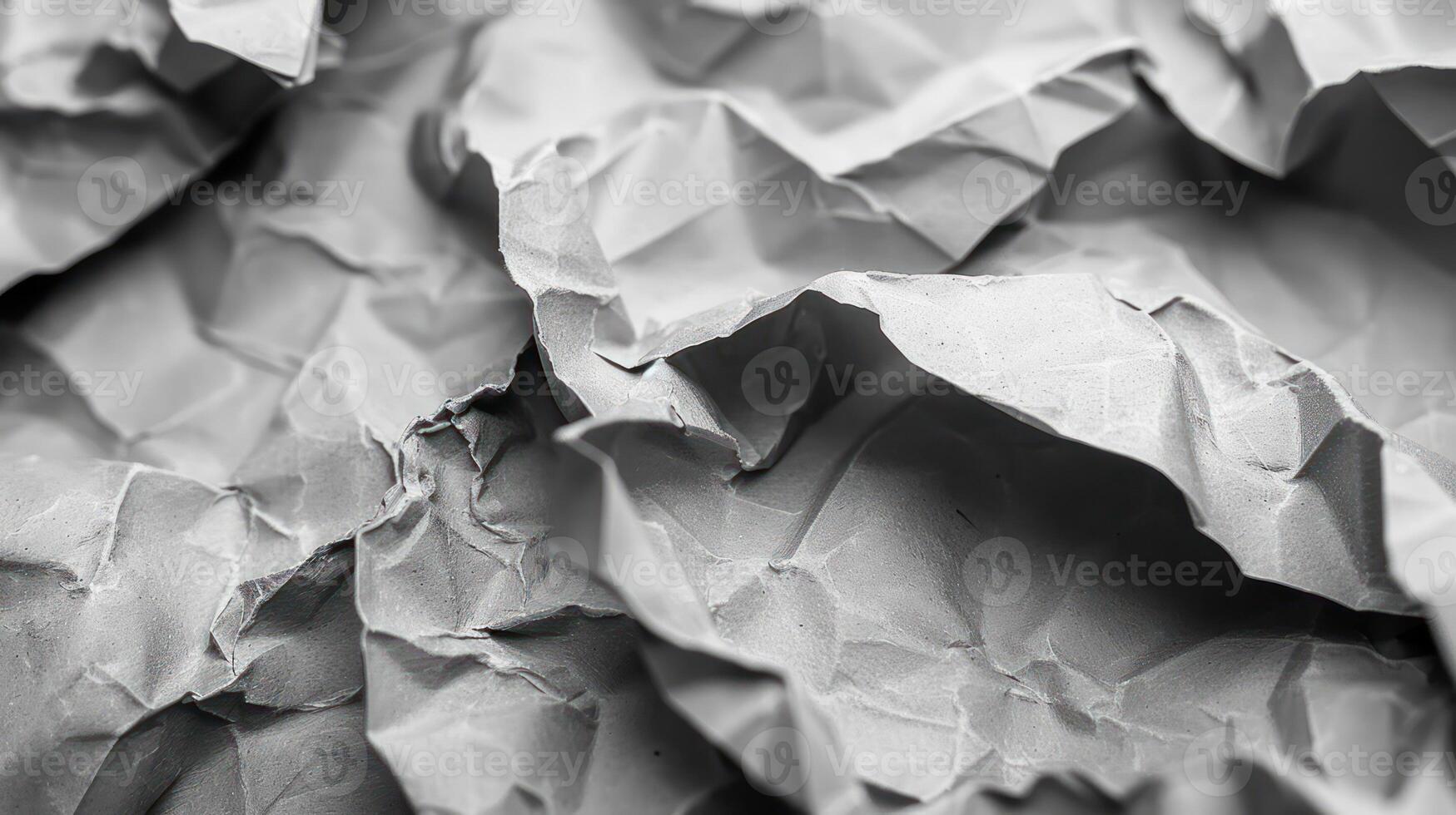 A close-up of crumpled gray paper, showcasing texture and depth. photo