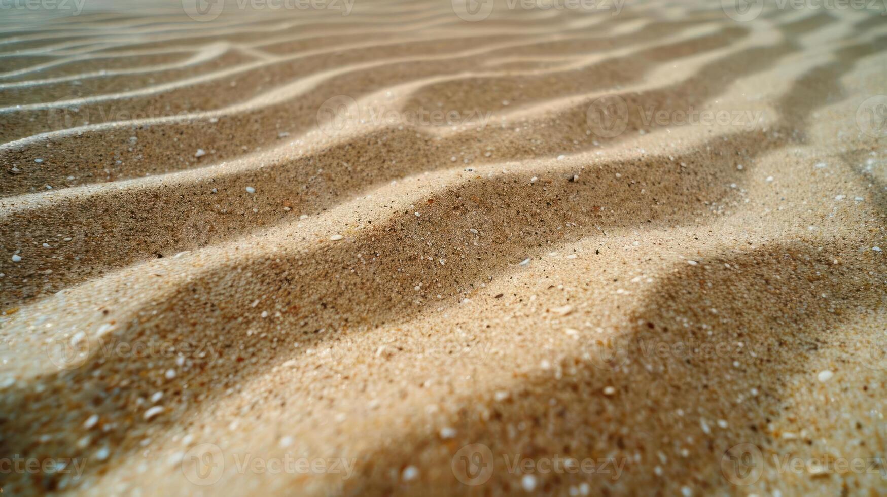 Close-up view of textured sandy surface with gentle ripples and shadows. photo
