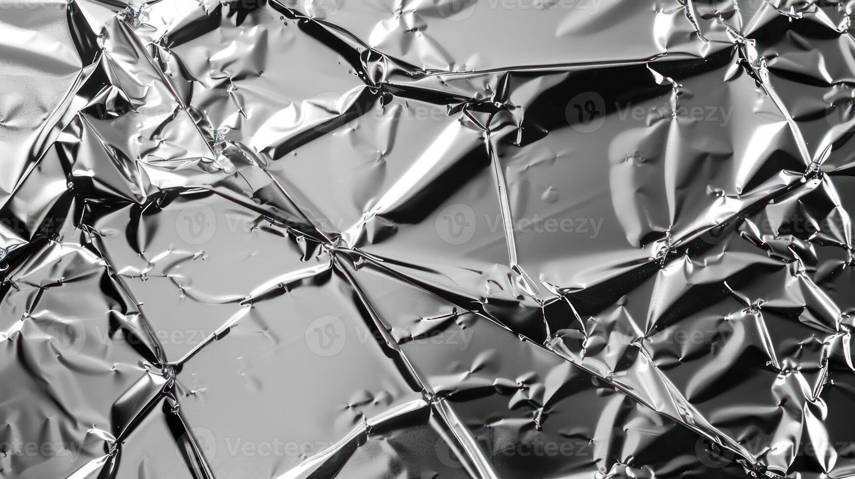 Crumpled metallic foil texture with reflections and shadows. photo