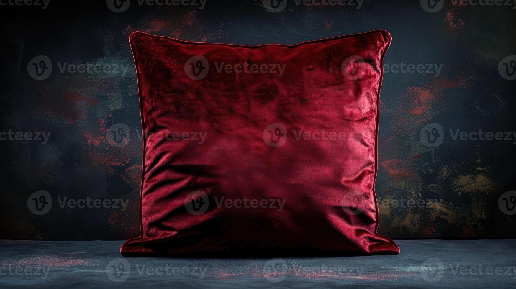 A plush red cushion against a textured dark background, emphasizing comfort and style. photo