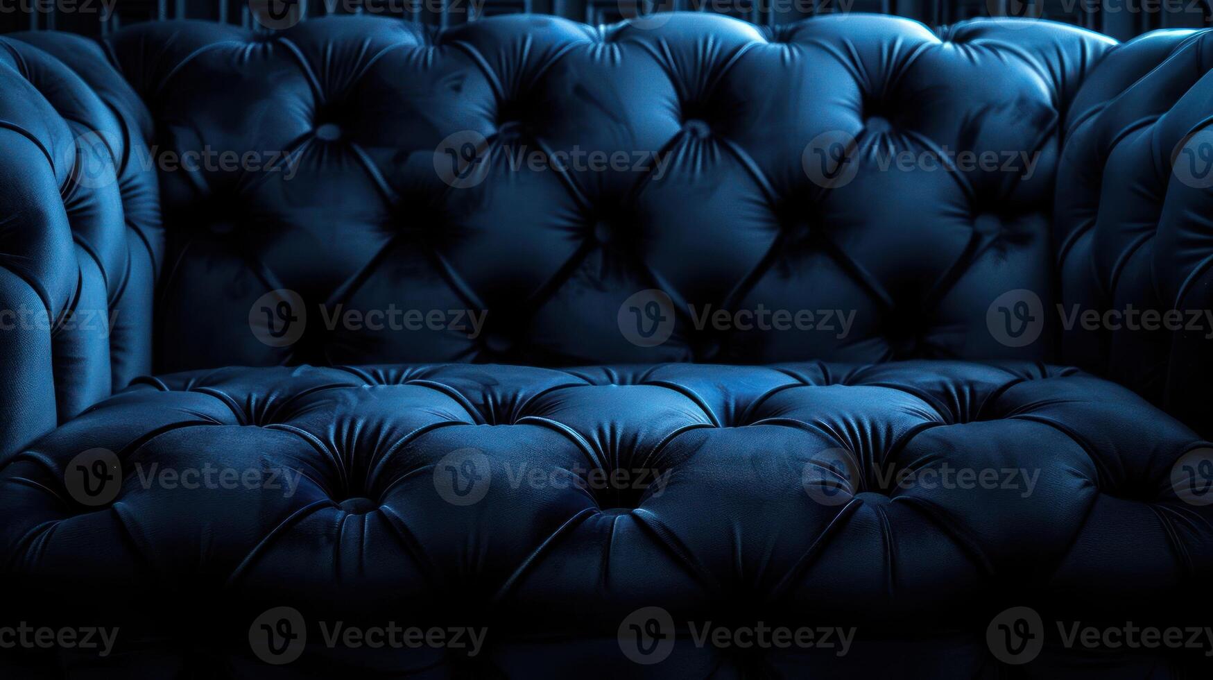 A close-up view of a plush, tufted blue sofa, emphasizing its texture and design. photo