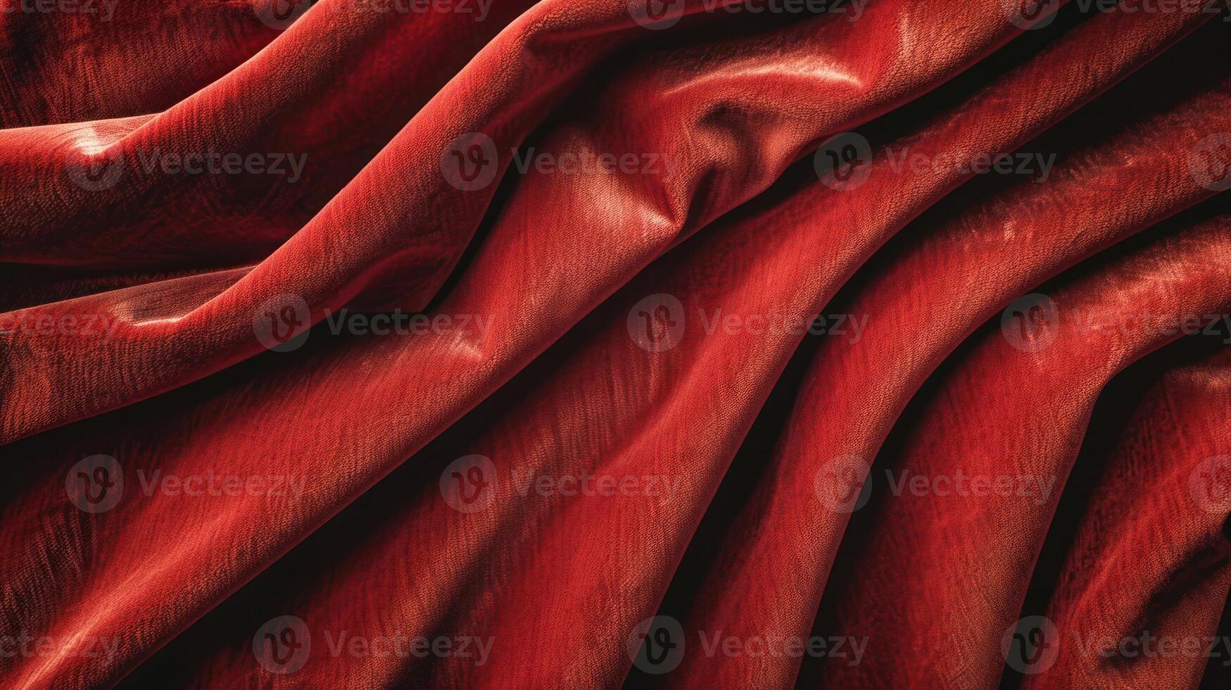 A close-up of luxurious red fabric, showcasing its texture and folds. photo