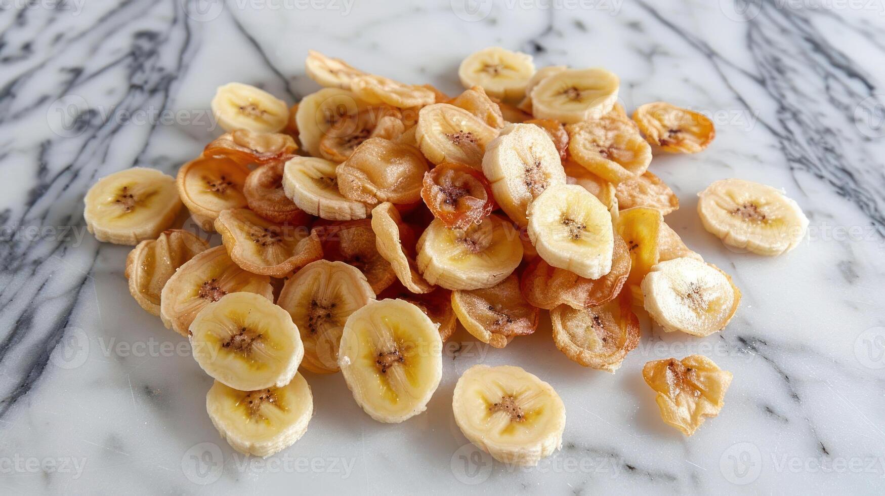 A pile of dried banana slices arranged on a marble surface. photo