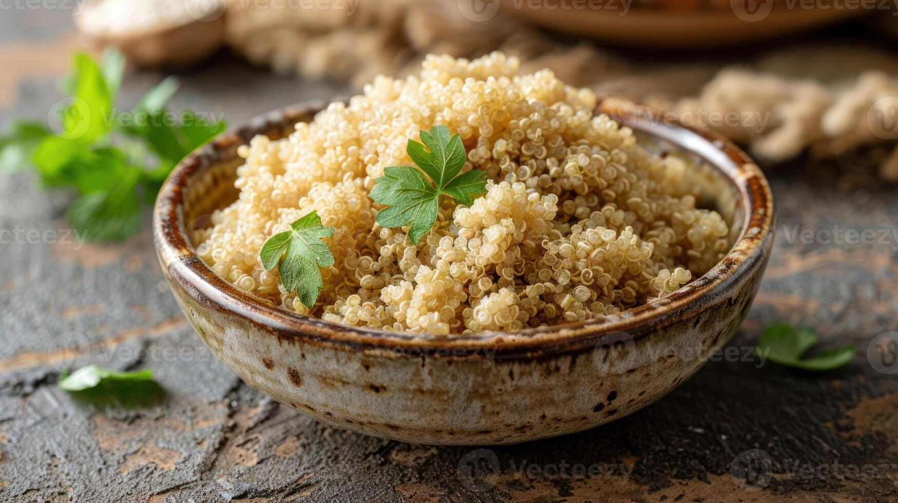 A bowl of cooked quinoa garnished with fresh parsley on a rustic wooden surface. photo