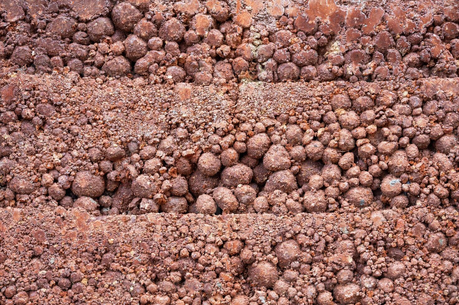Full frame shot of rough earthen wall texture. These walls are constructed by ramming a mixture of aggregates, including gravel, sand, silt and a small amount of clay. photo