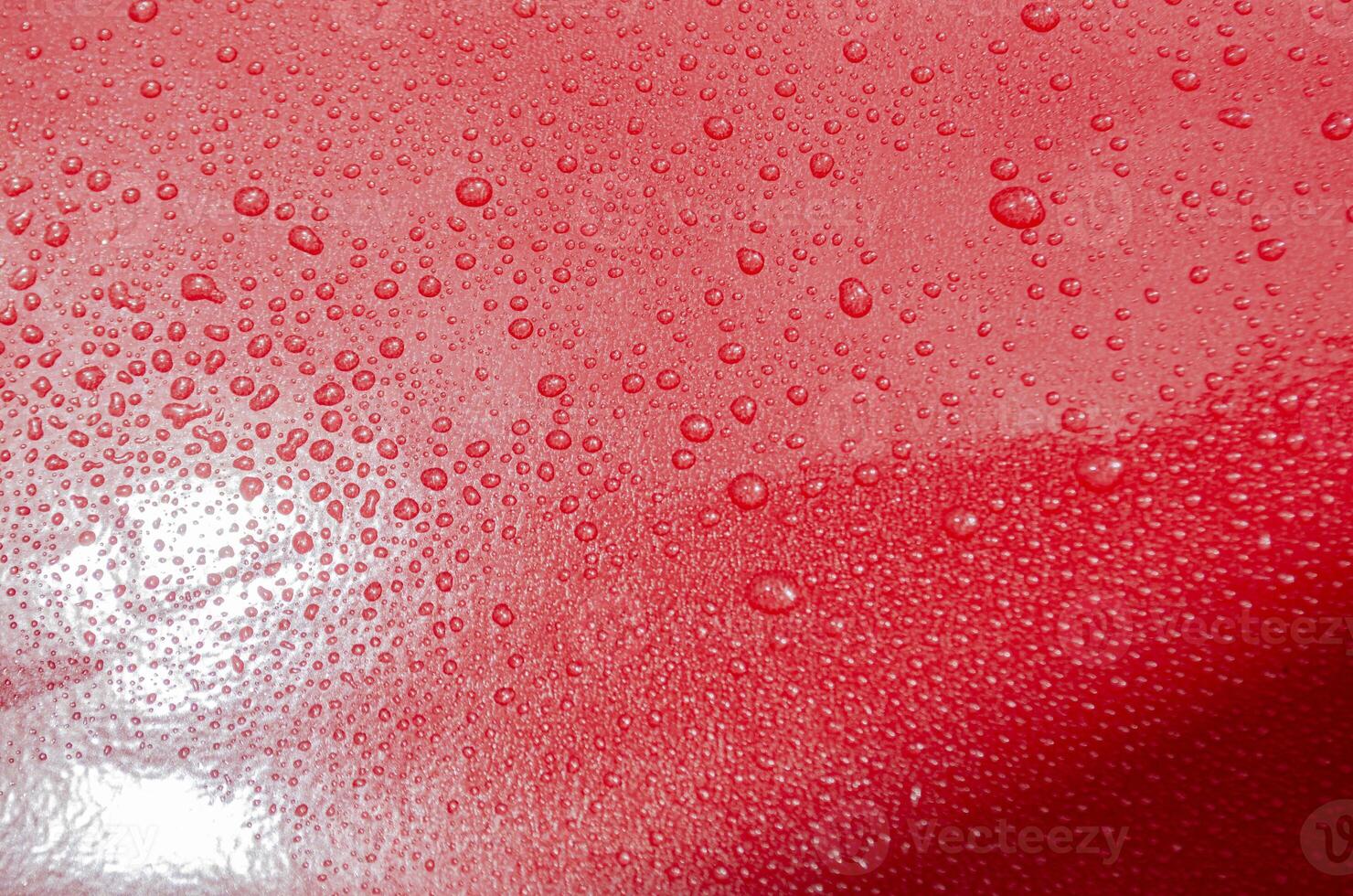 Rain water droplets with bright red color background suitable for wallpaper photo