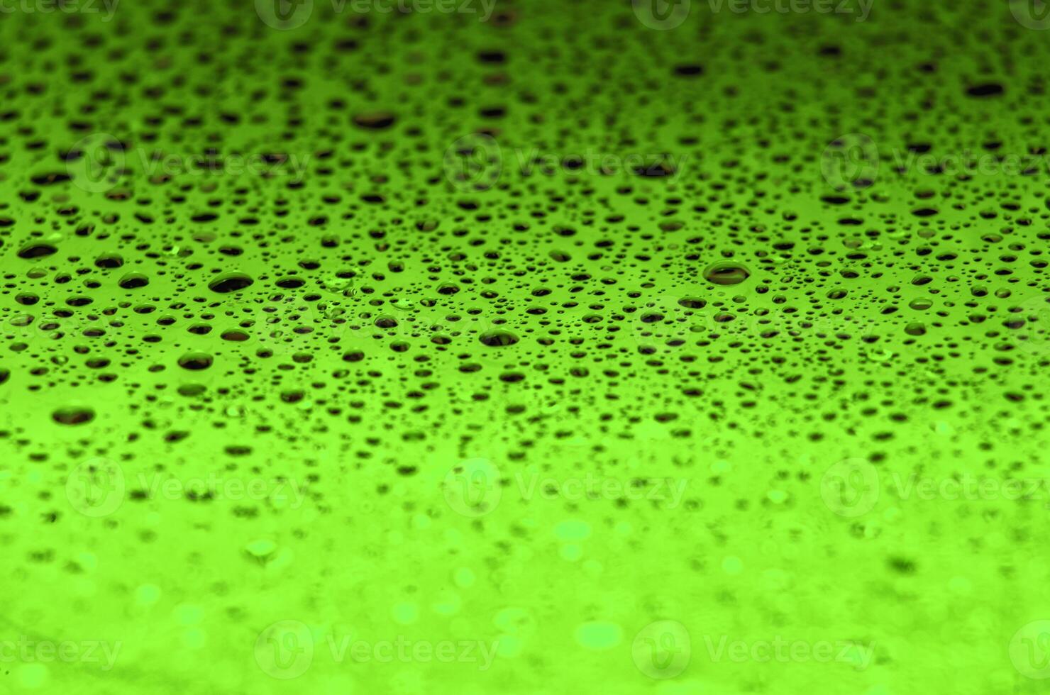 Rain droplets on a dark green color background with customizable space for text or ideas photo