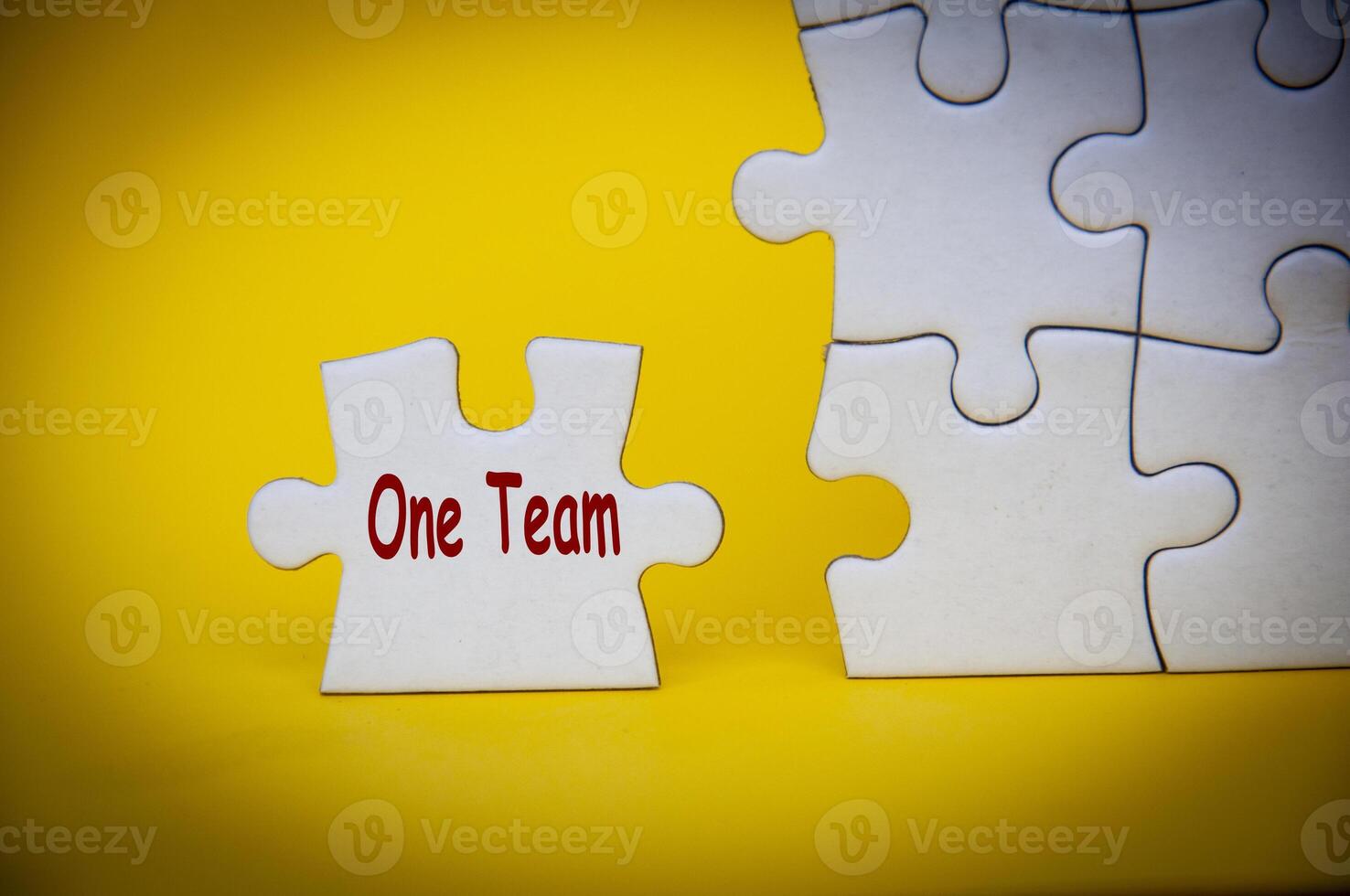 One Team text on separated jigsaw puzzle. One team and teamwork concept photo