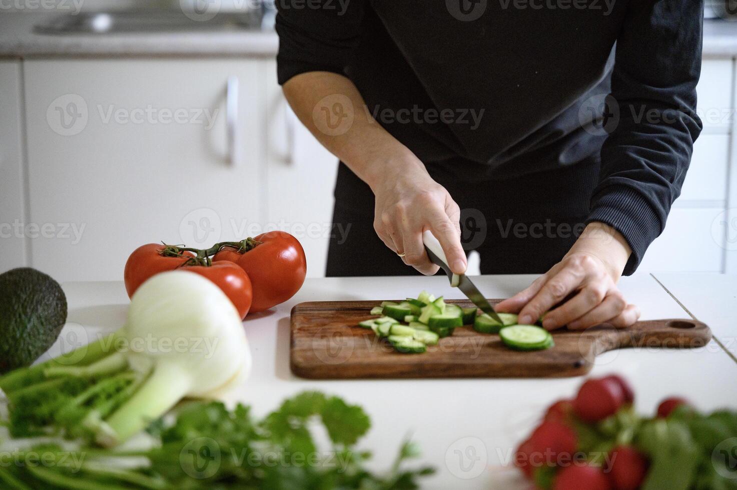 Preparing healthy food or a salad. Fresh vegetables and herbs on the table. photo