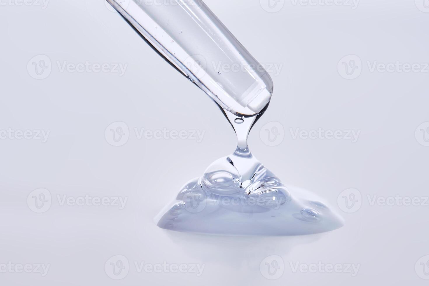 Pipette with delicate blue serum close-up. photo