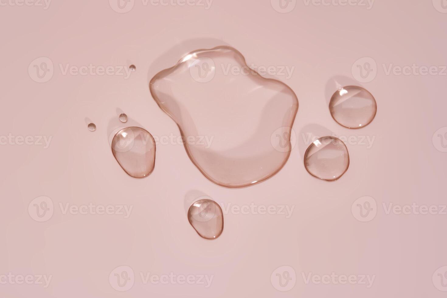The texture of micellar water on a pink background. photo