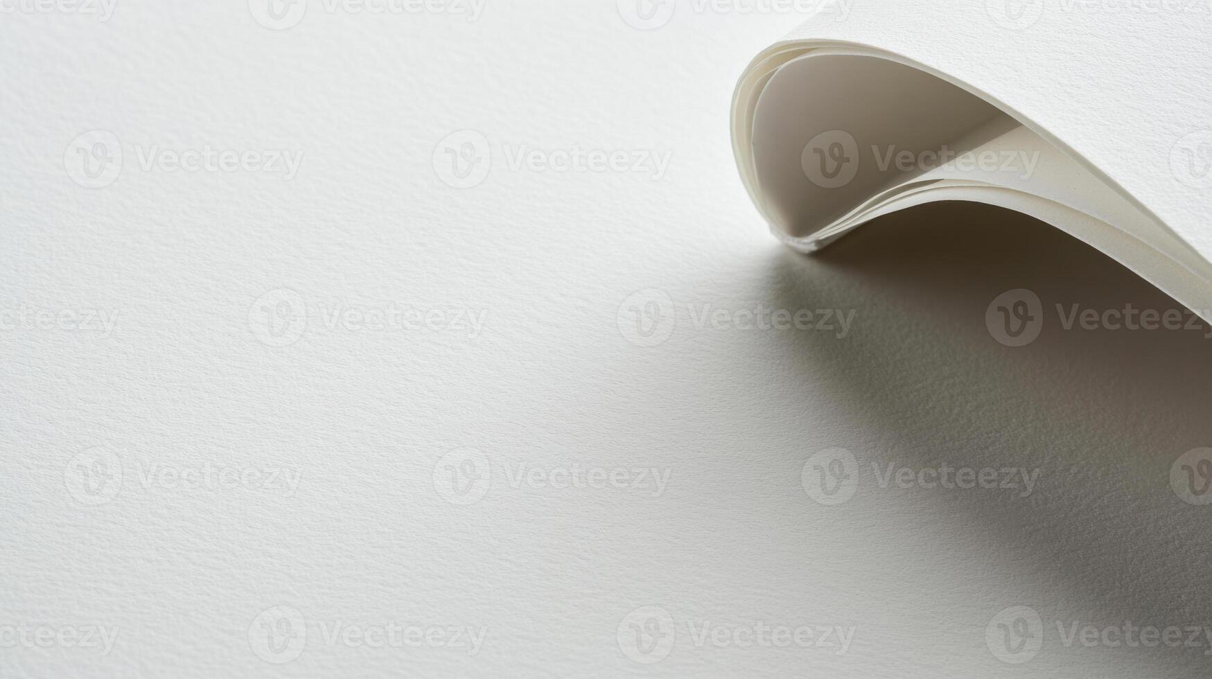 A folded piece of paper on a white surface photo
