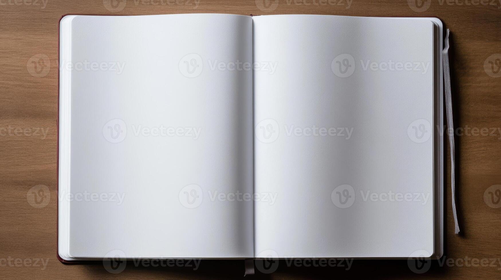 An open white notebook on a wooden table photo