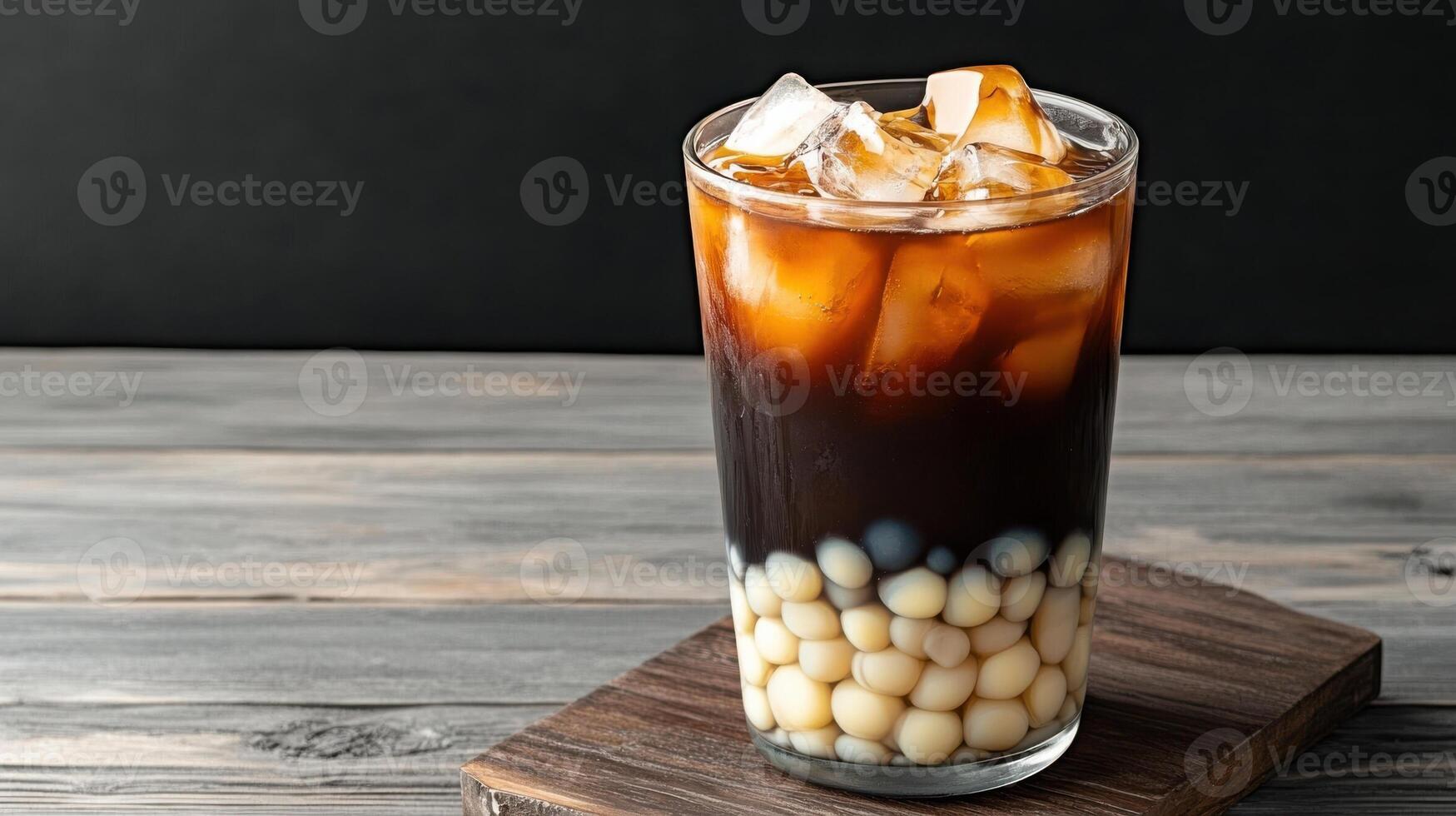An iced coffee with ice cubes on top photo