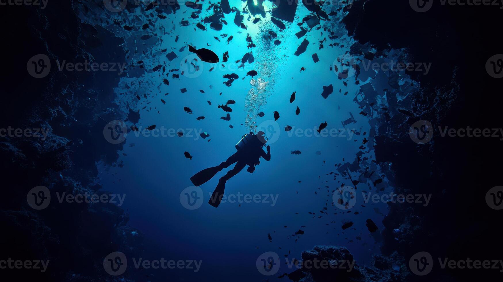 Diver exploring deep sea surrounded by plastic debris and fish photo
