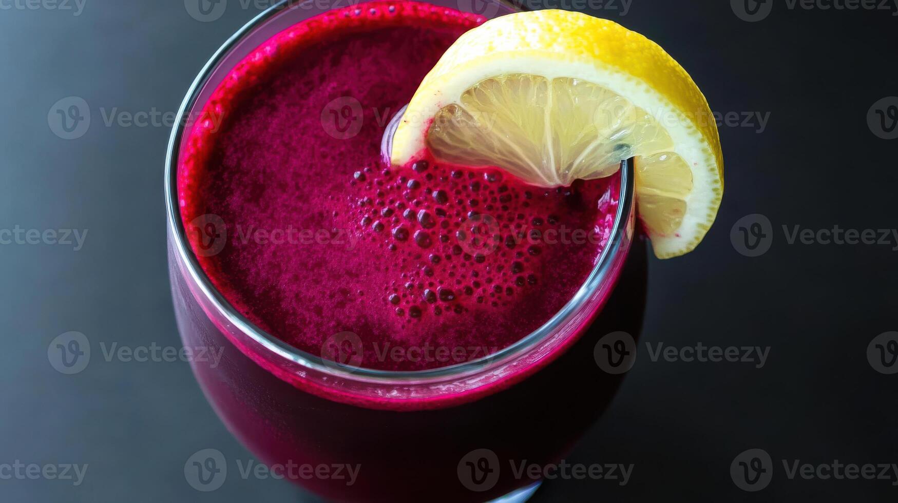 A glass of beet juice with a lemon wedge photo