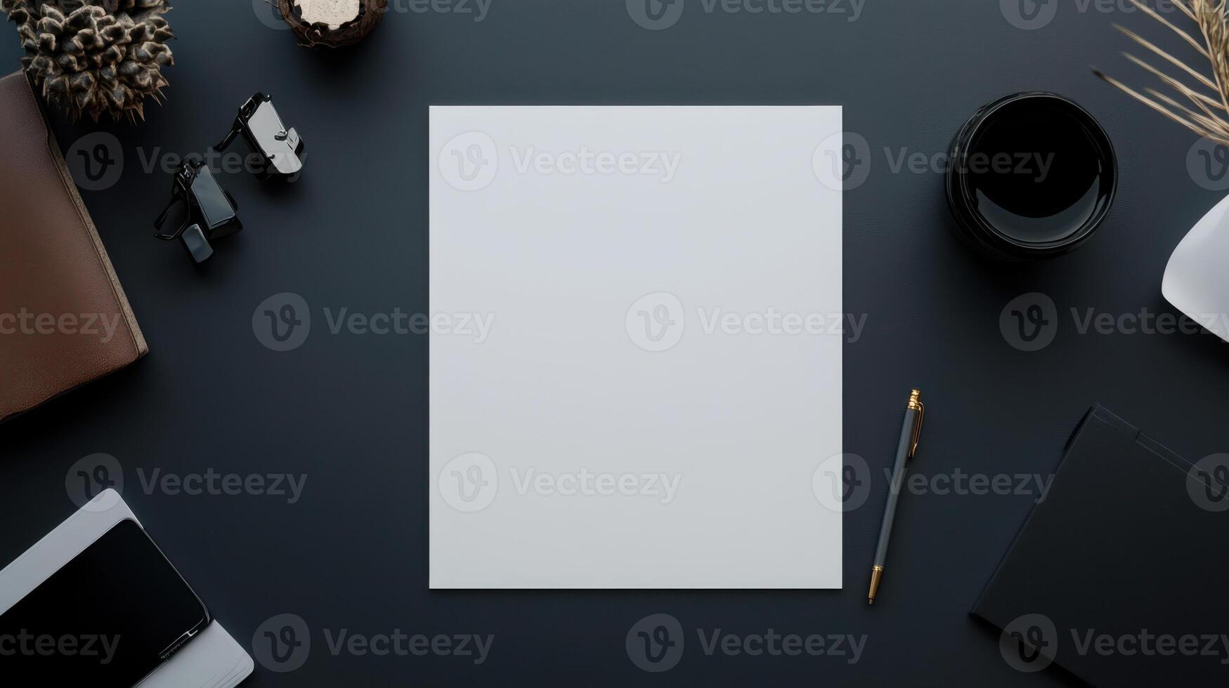 flat lay of blank sheet of white paper on dark desk with accessories photo