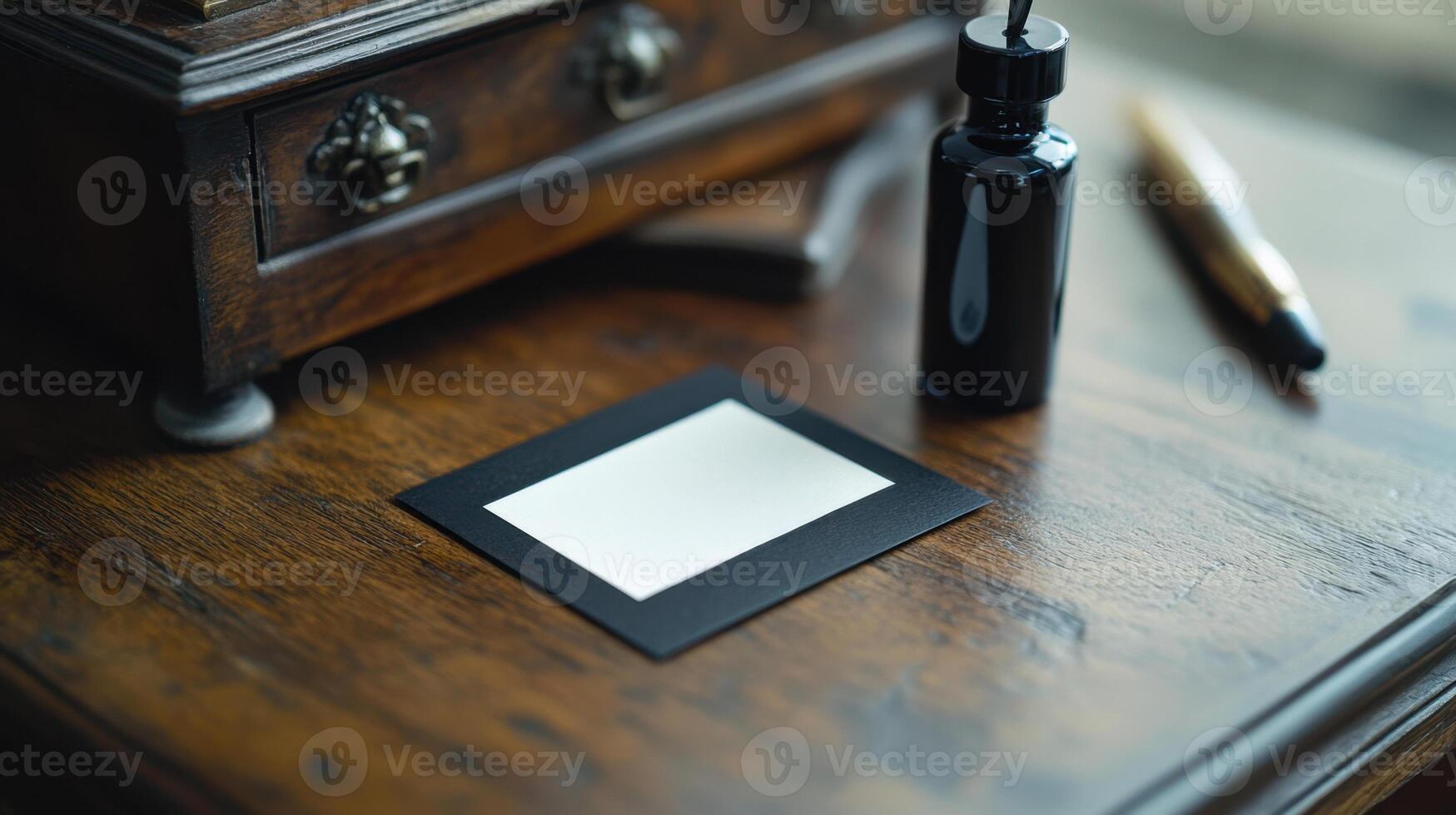 A black and white square is sitting on top of a wooden desk photo