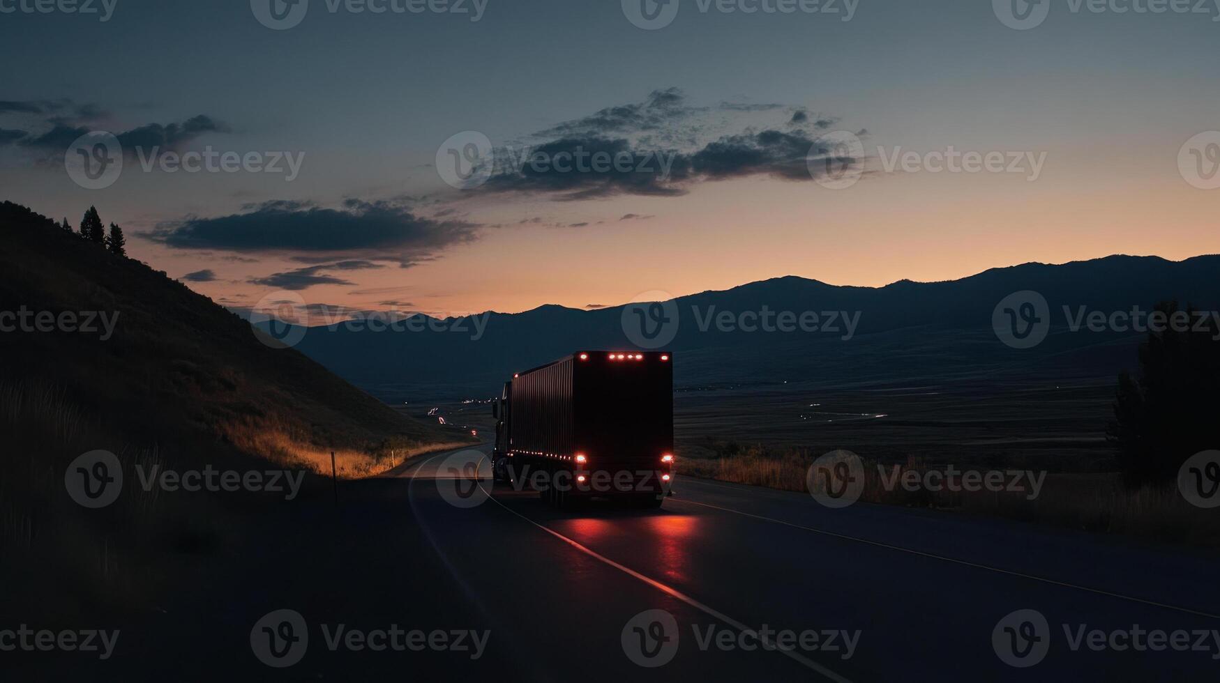 A truck driving down a road at dusk photo