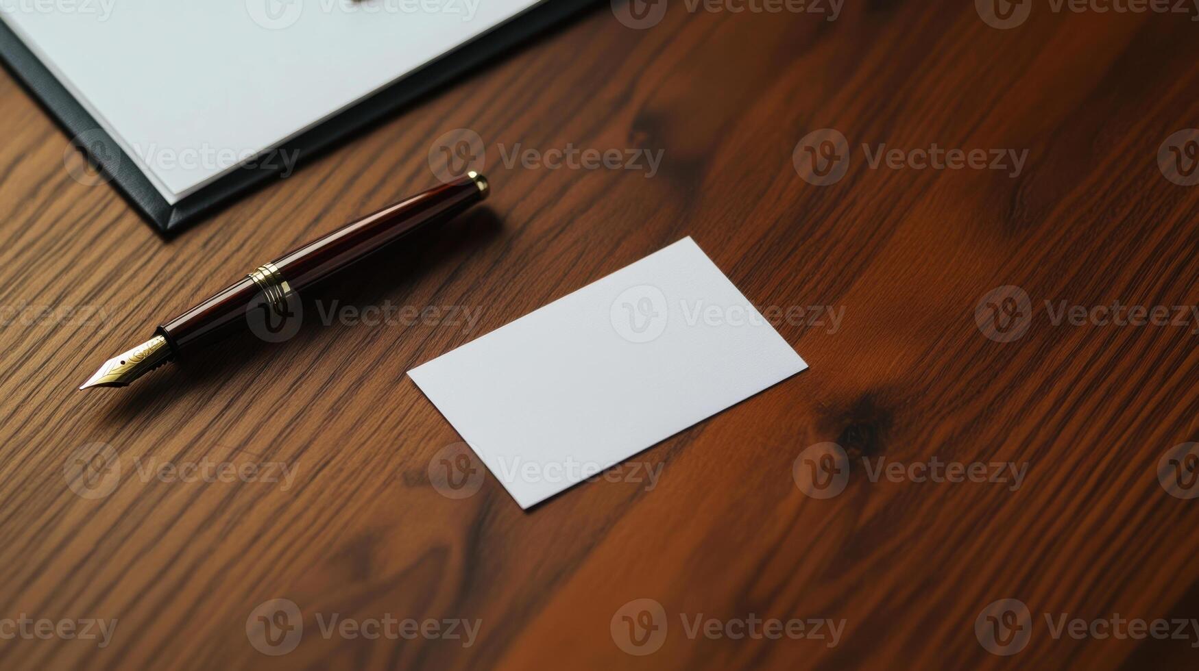 Business card on wooden desk with pen and notepad photo
