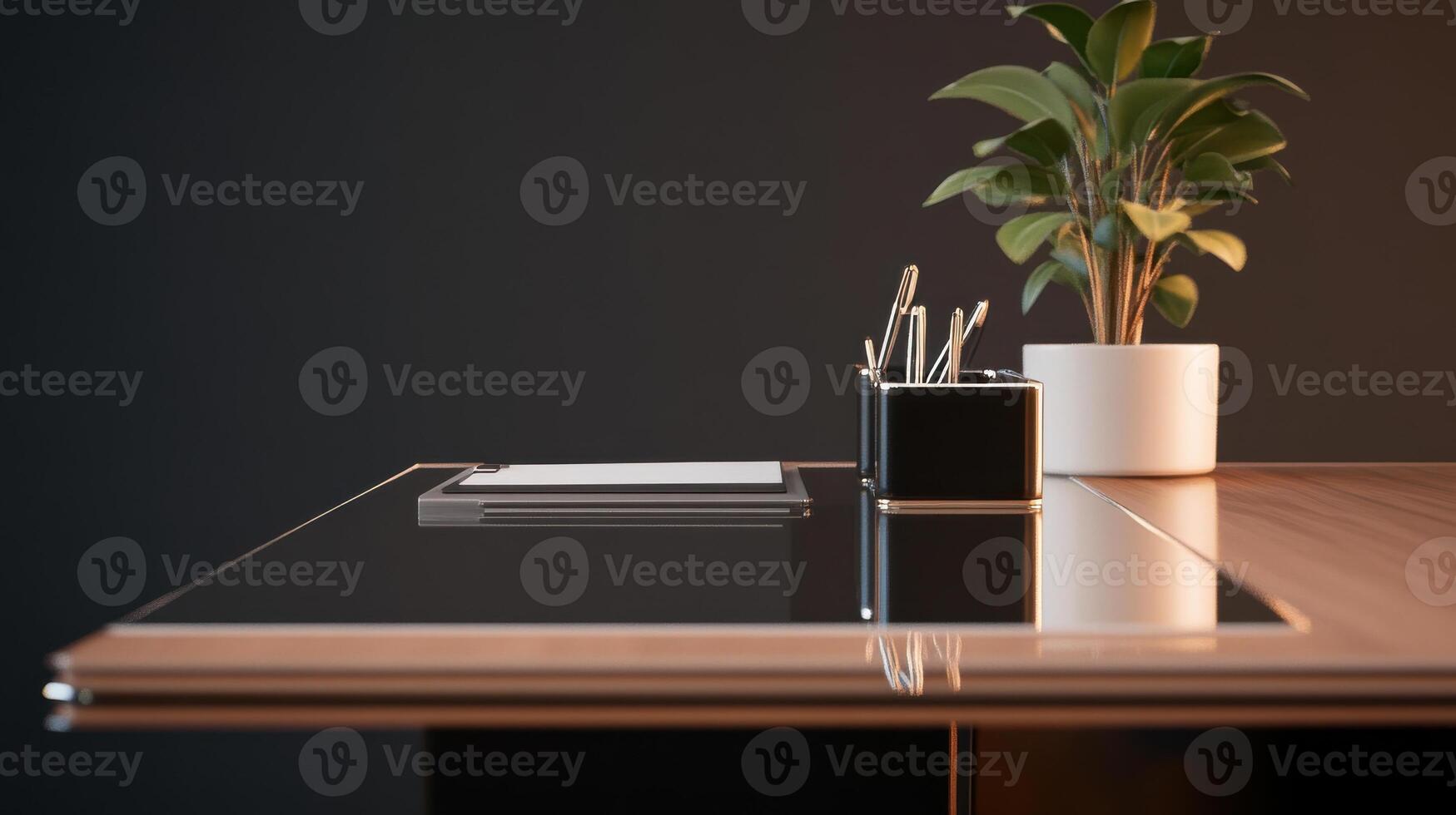 A desk with a plant and a pen on it photo