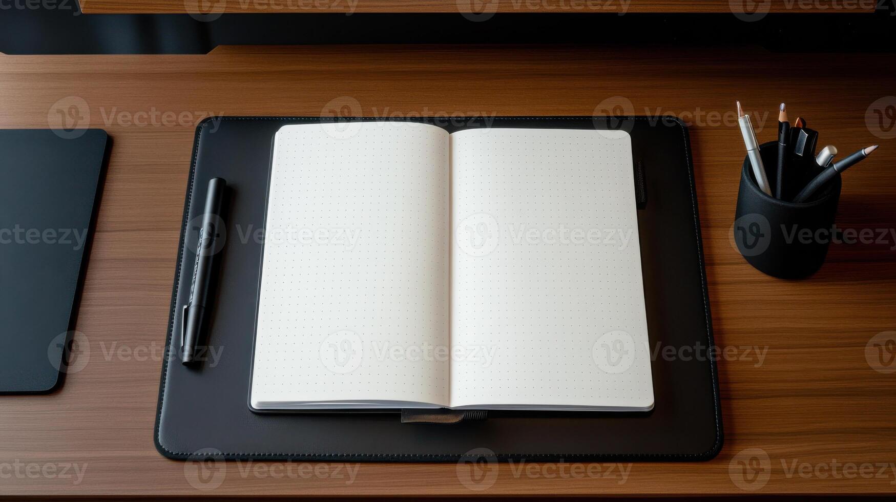Notebook, pen, and pencils on a desk photo