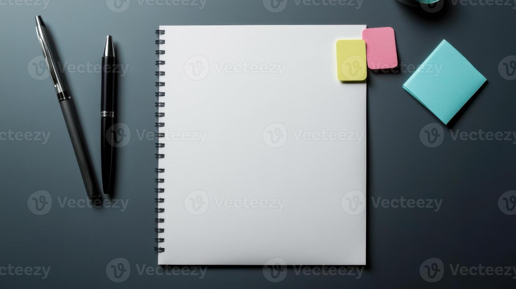 Blank notebook, pen, pencil, sticky notes and notepad on dark background photo