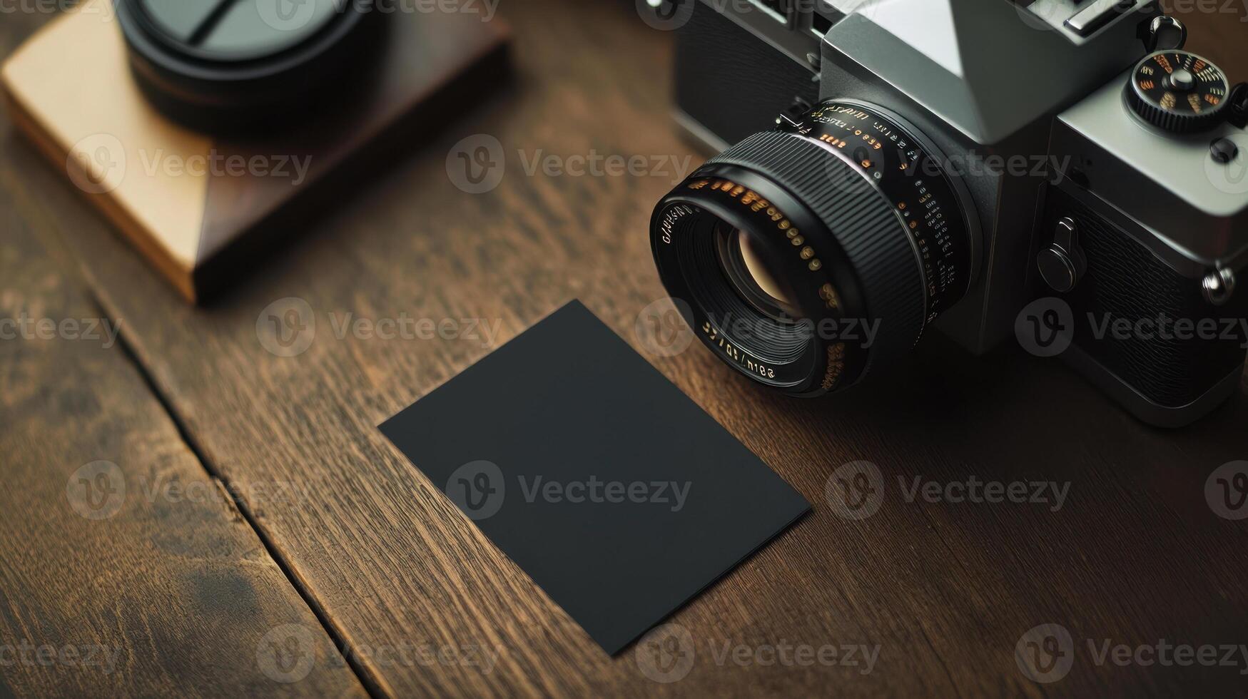vintage camera beside blank business card on wooden table photo