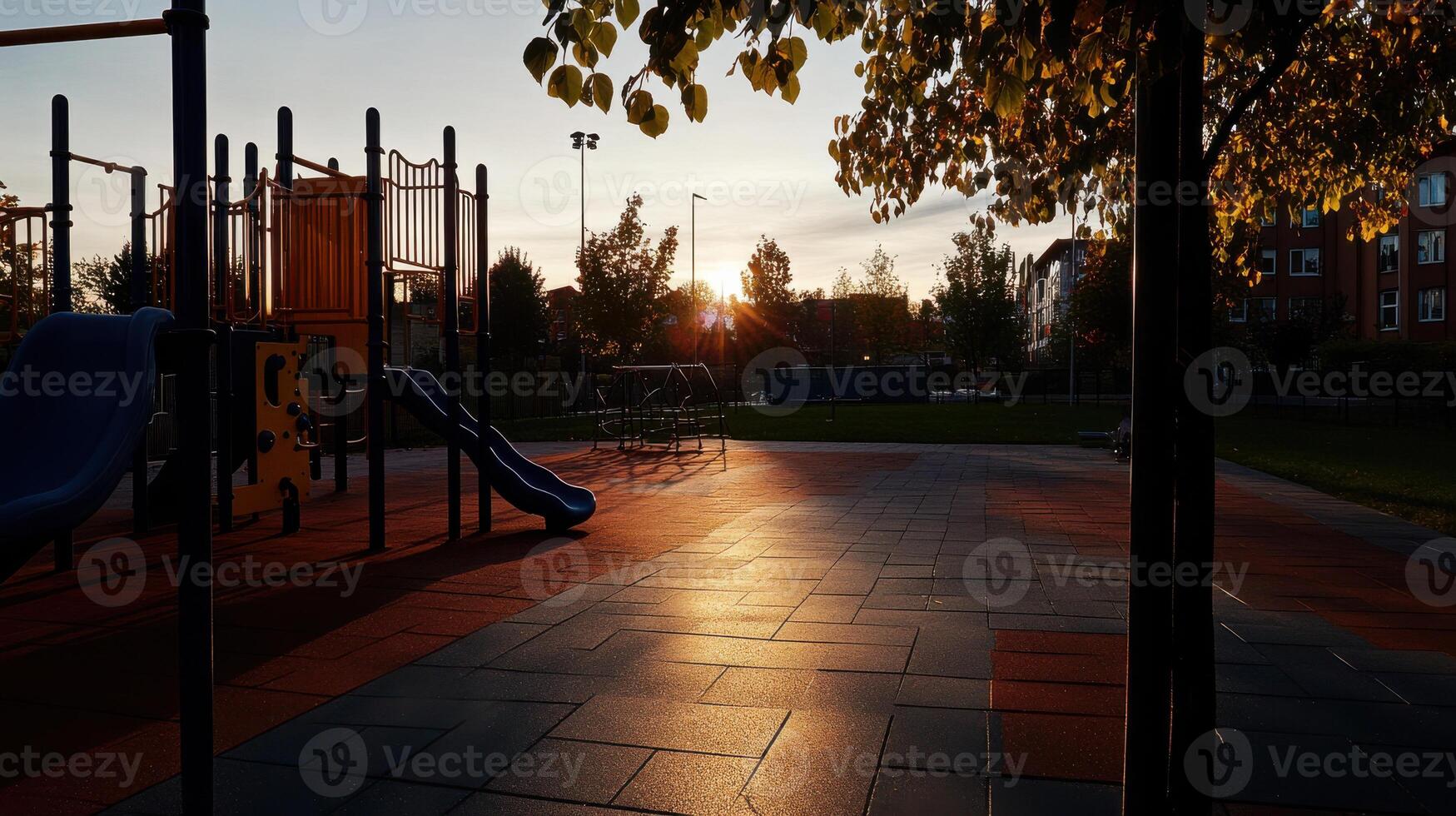 playground at sunset with slides and play structures, casting long shadows photo